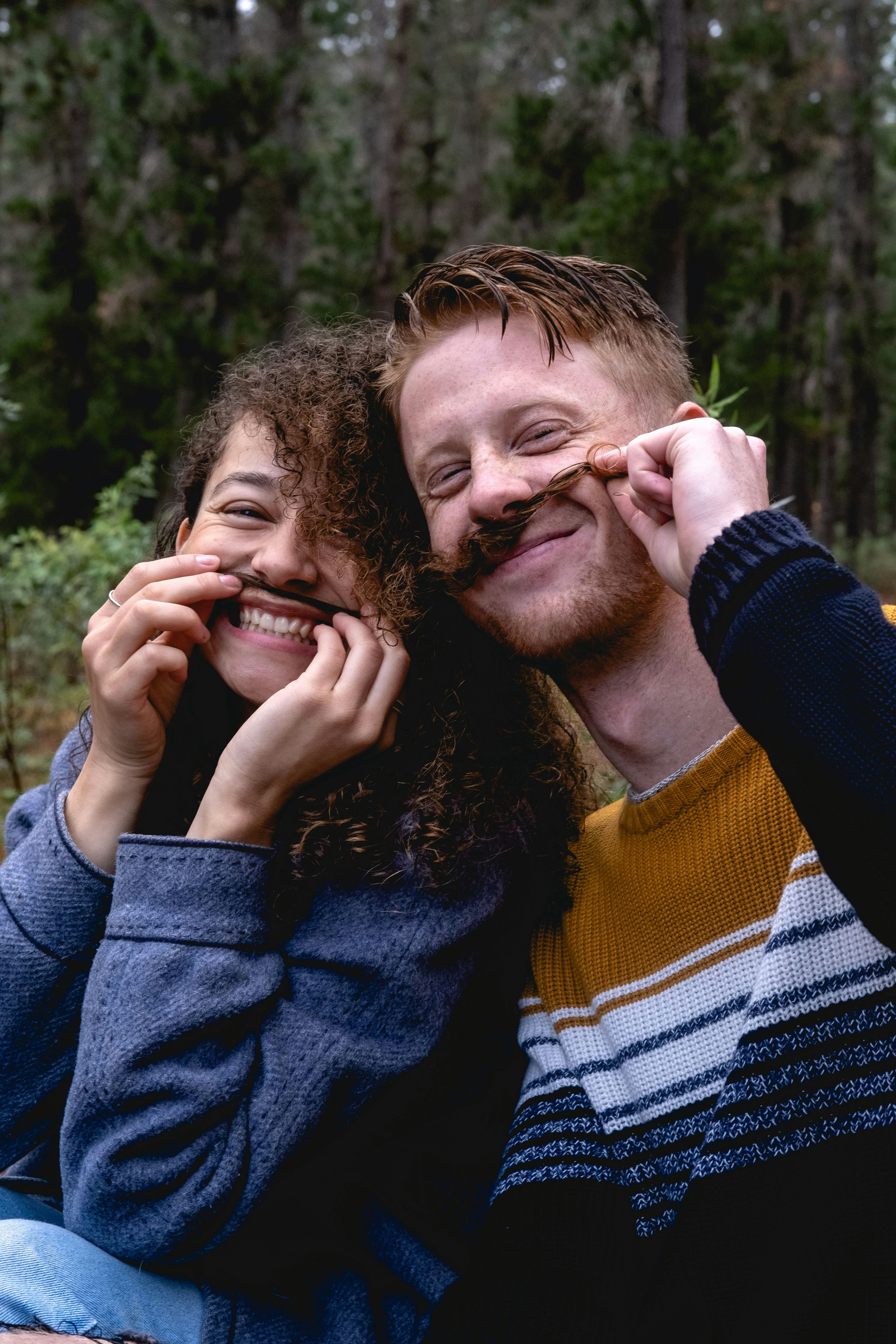 A couple sharing a playful, connected moment outdoors